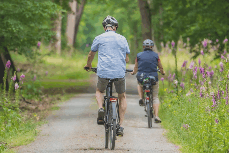 Man and woman biking on a nature trail