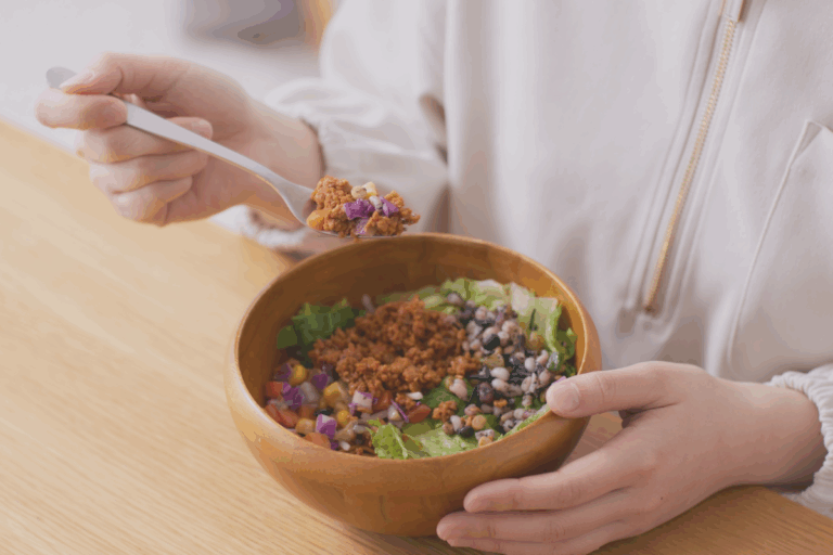 Photo of someone eating plant-based diet from the neck down